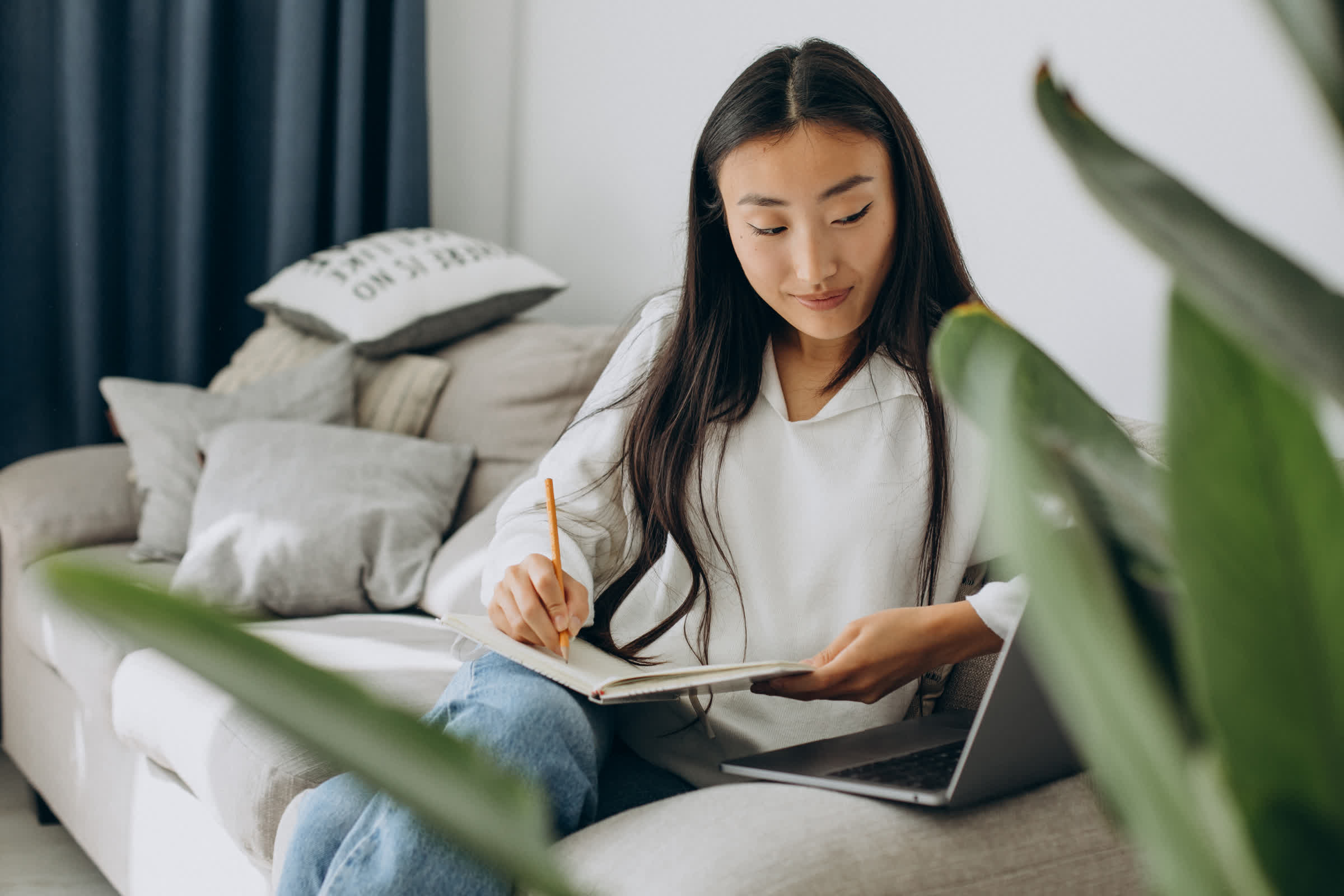 resized_asian-woman-studying-home-reading-sofa