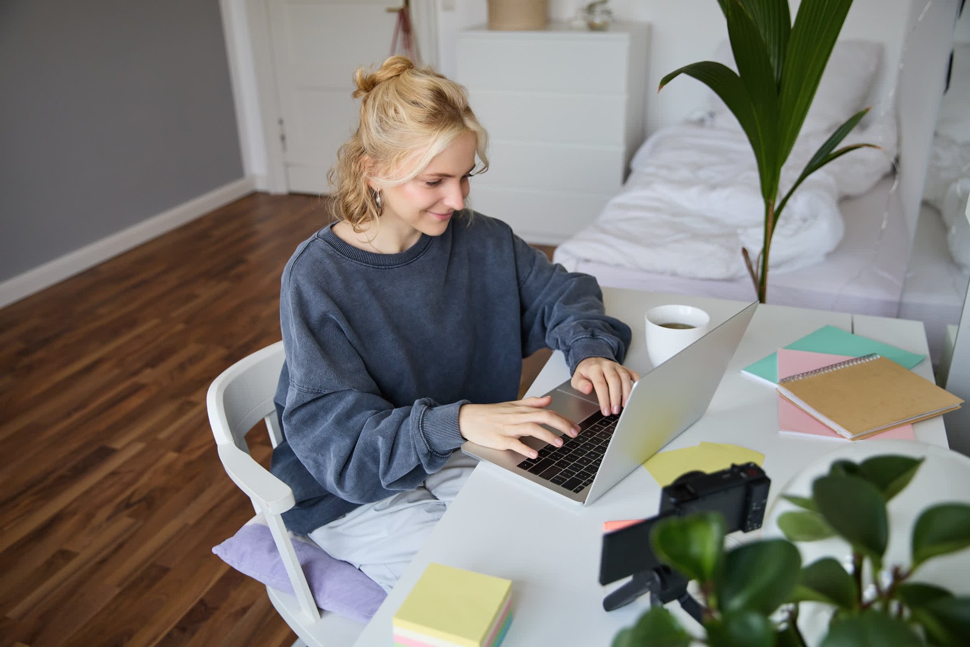 resized_portrait-young-woman-distance-learning-working-from-home-with-laptop-making-notes-student