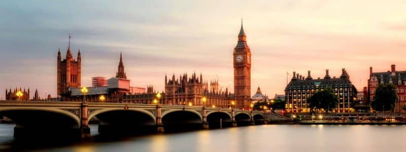 A stunning twilight view of London's iconic Westminster skyline featuring Big Ben, the Houses of Parliament, and Westminster Bridge reflected in the Thames River, showcasing why London ranks among the best cities in the UK for its historic architecture and breathtaking urban landscapes.